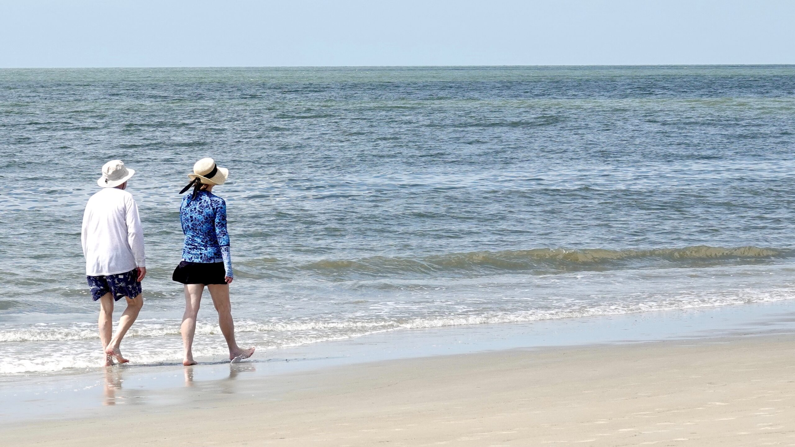 man and woman walking along the beach in Hilton Head South Carolina