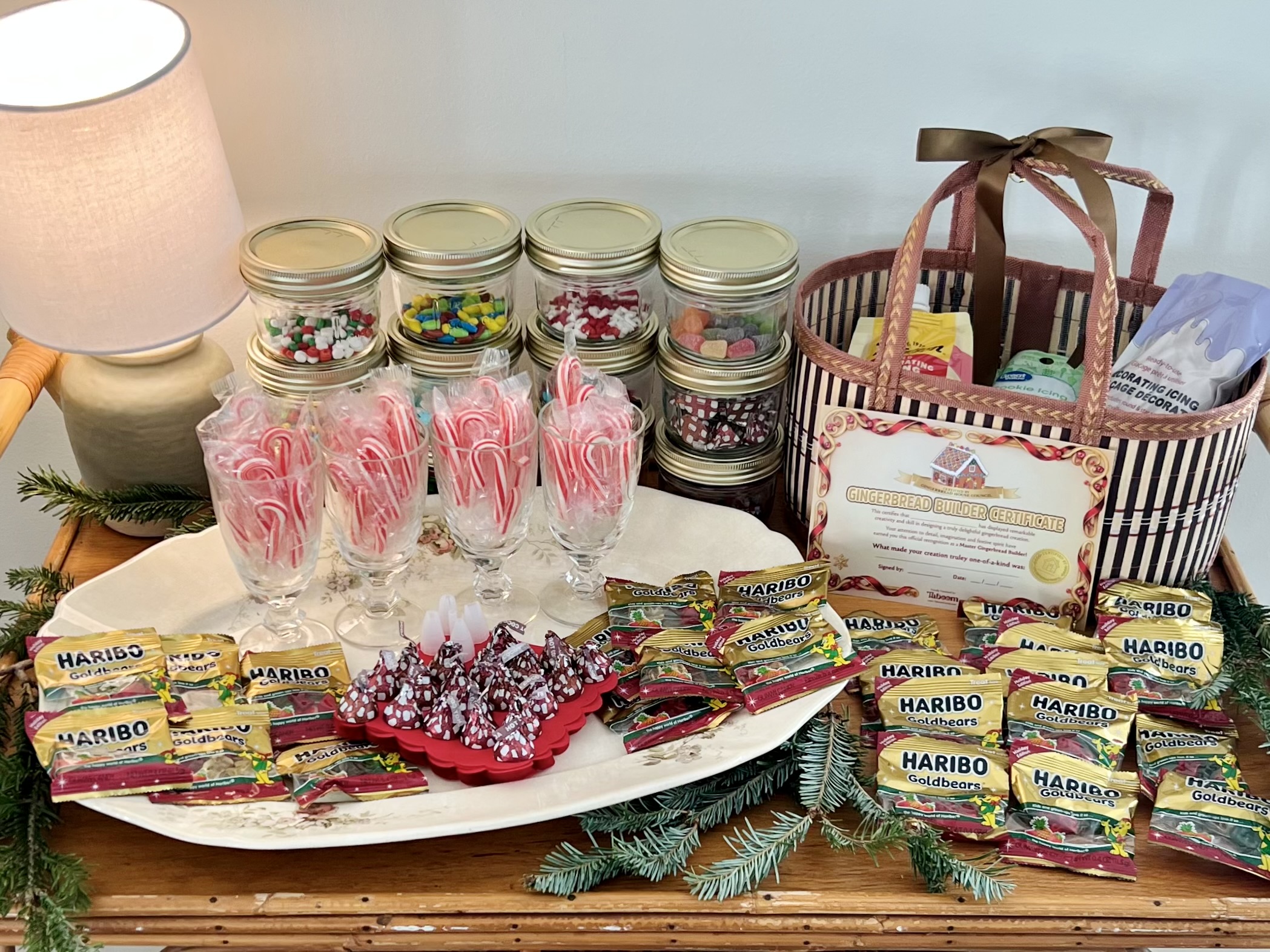 A gingerbread building kit that includes gummy bears, peppermint sticks, M & M candies and treats